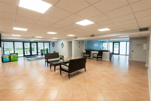 a lobby with furniture and a potted plant