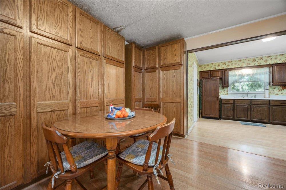 59380 10 Mile Road South Lyon, MI 48178 - Photo 18 of 53 Wood-finish flooring throughout, extensive built-in cabinetry, and a spacious kitchen area with ample counter space
