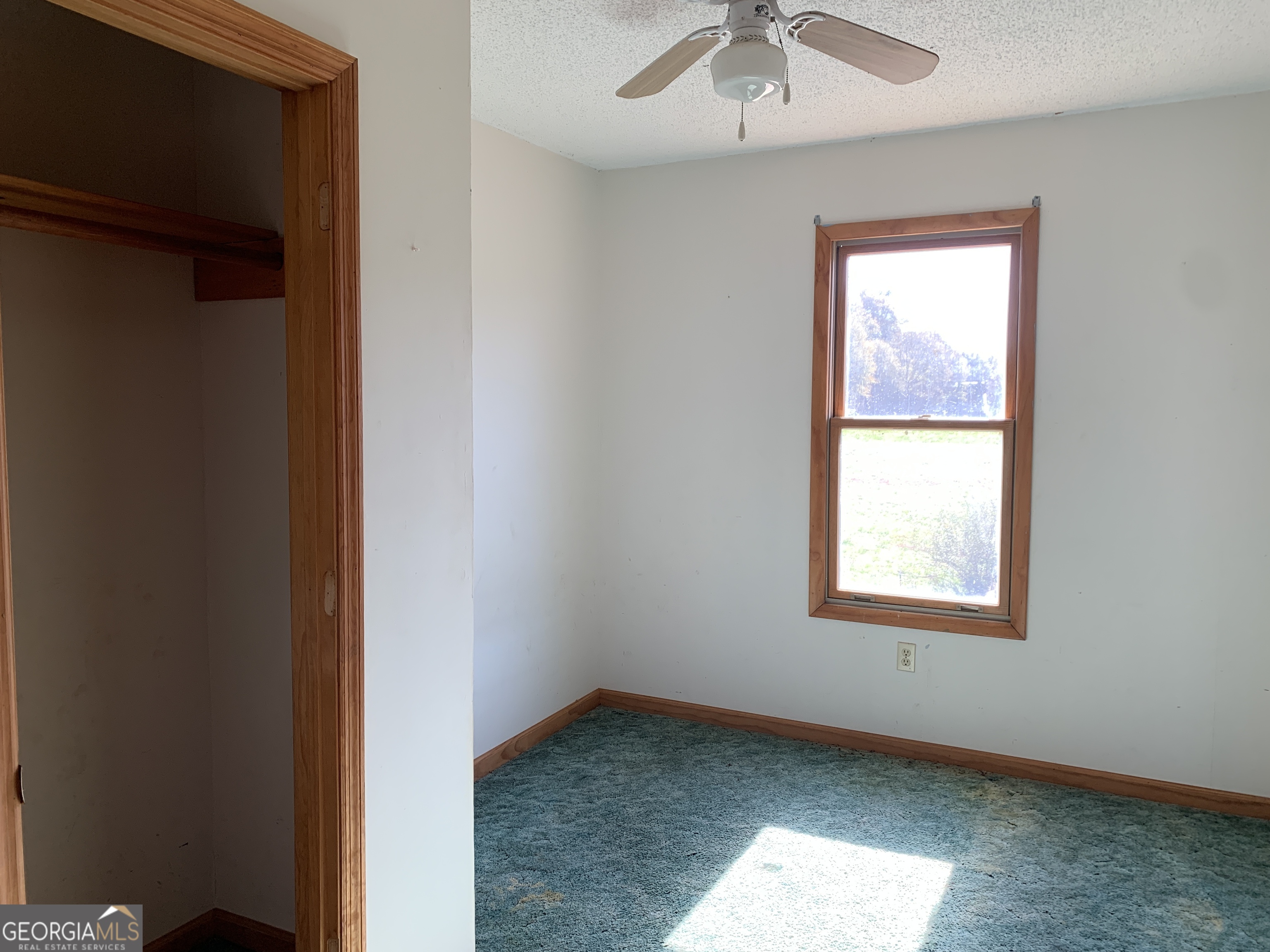 222 Reno Road Royston, GA 30662 - Photo 13 of 15 an empty room with a window and a fan