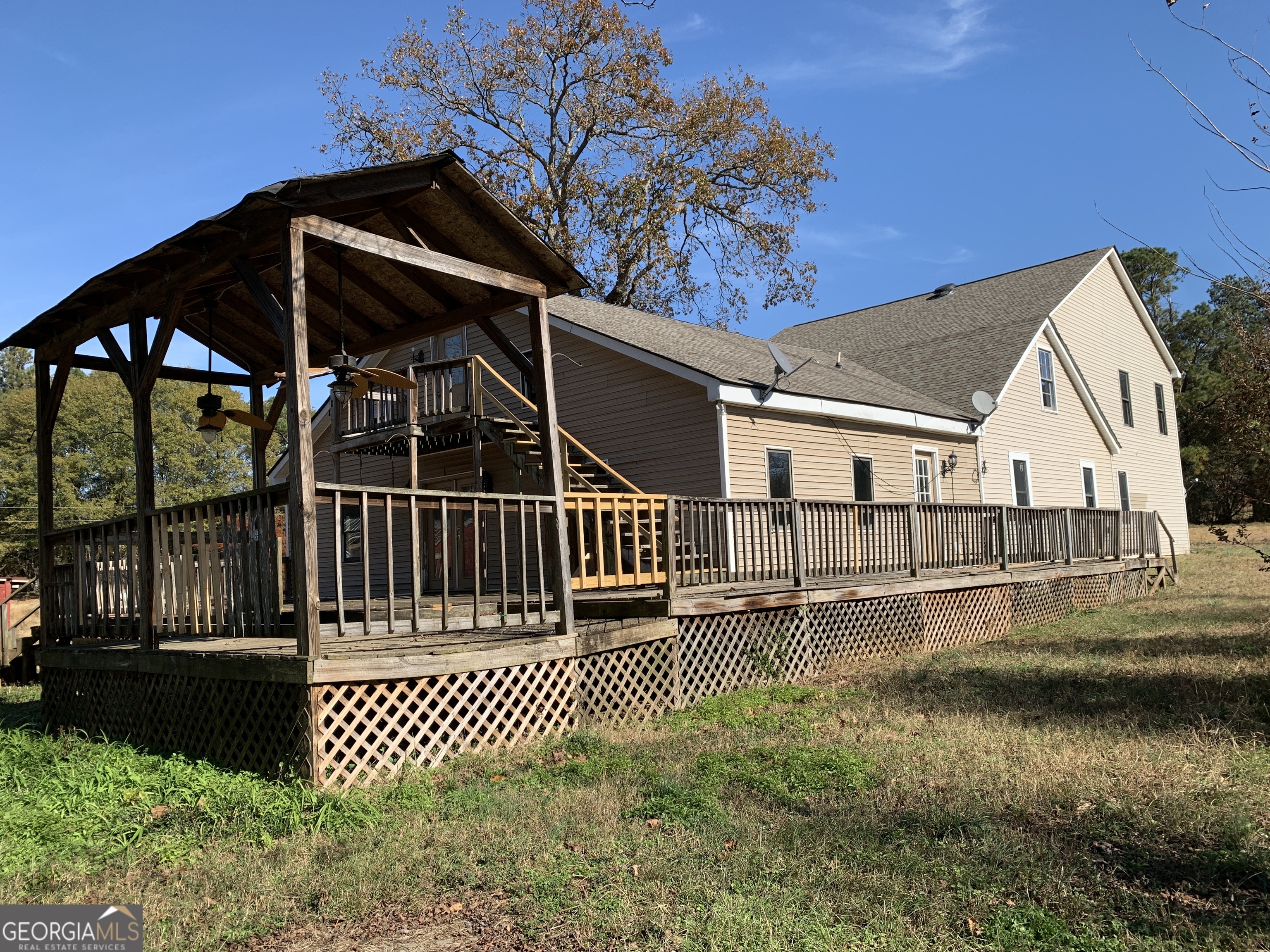 222 Reno Road Royston, GA 30662 - Photo 2 of 15 a view of a house with a wooden deck