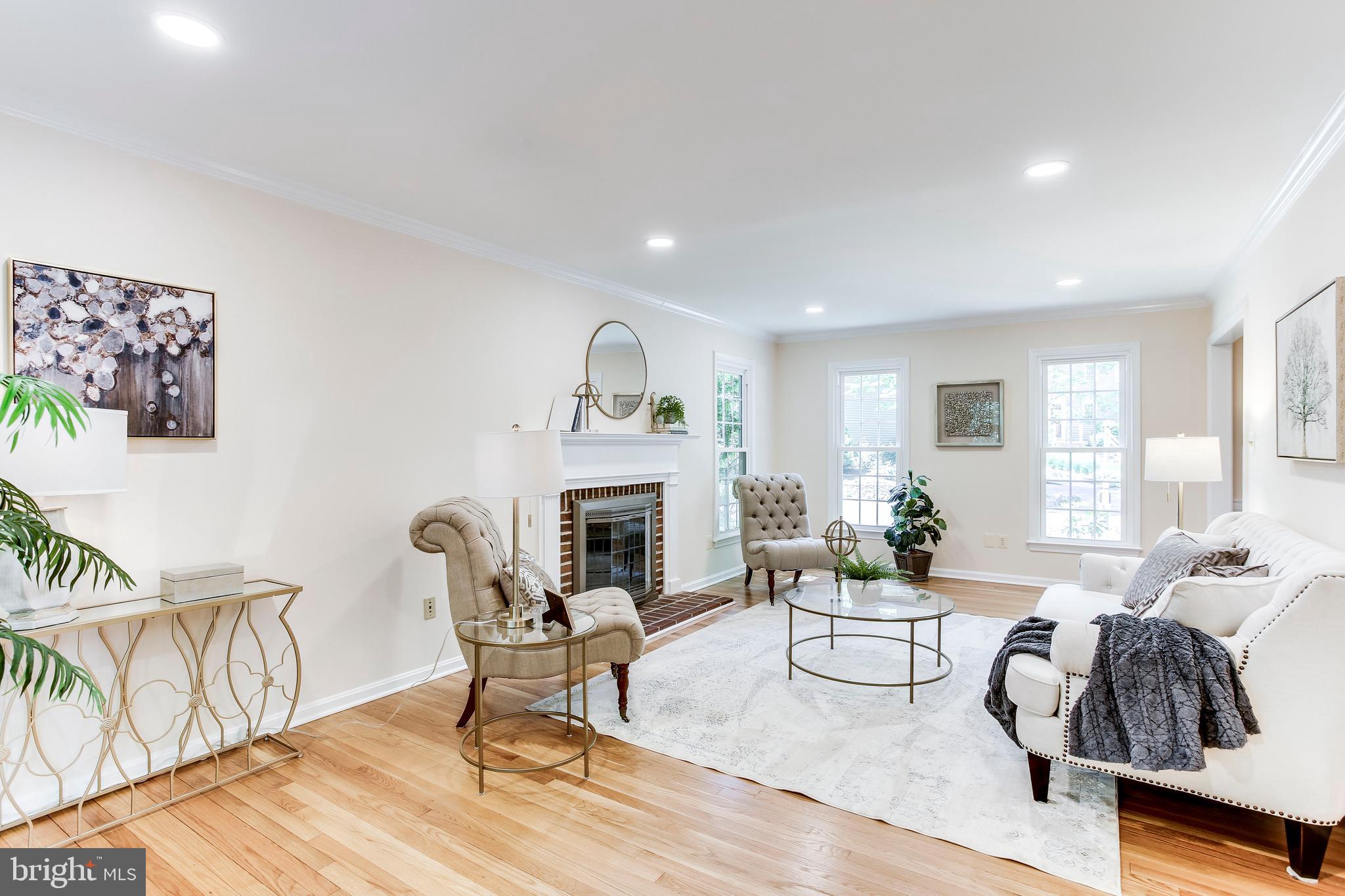 2093 Cobblestone Lane Reston, VA 20191 - Photo 8 of 43 Open living room with brick lined fireplace
