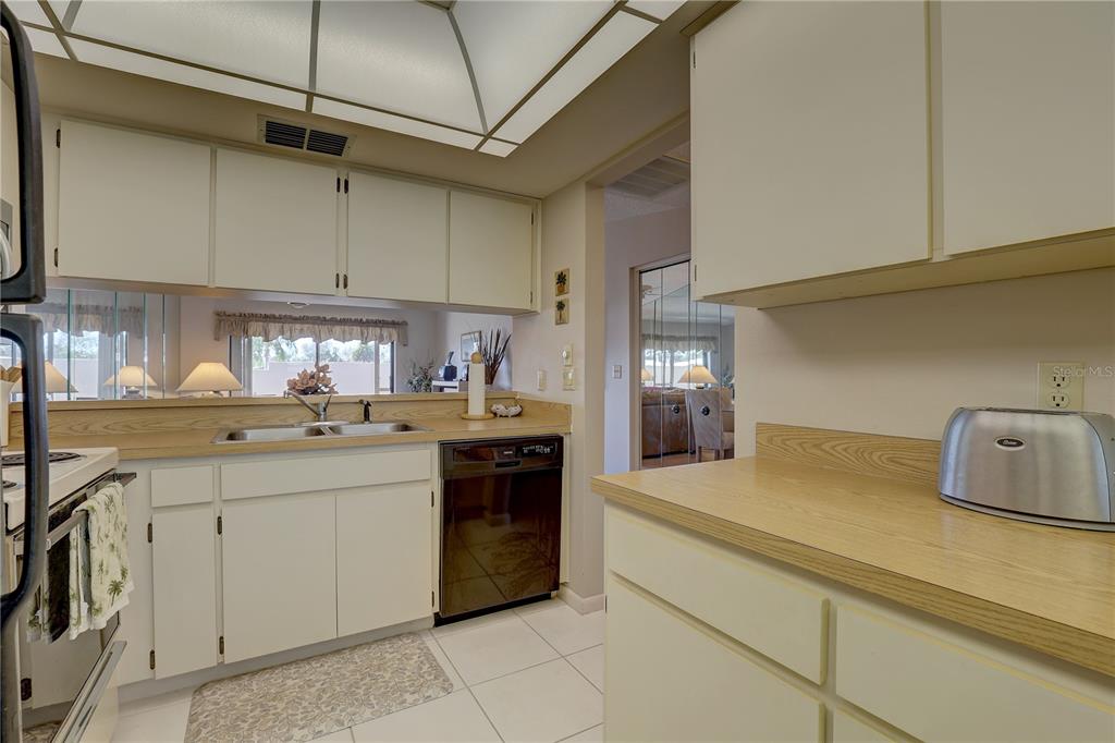 2131 Ridge Road South, Unit 132 Largo, FL 33778 - Photo 15 of 32 a kitchen with a sink cabinets and appliances