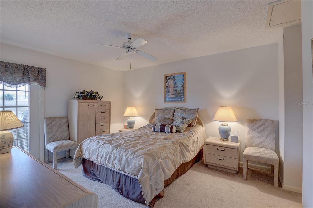 2131 Ridge Road South, Unit 132 Largo, FL 33778 - Photo 17 of 32 a bedroom with a bed and a chandelier