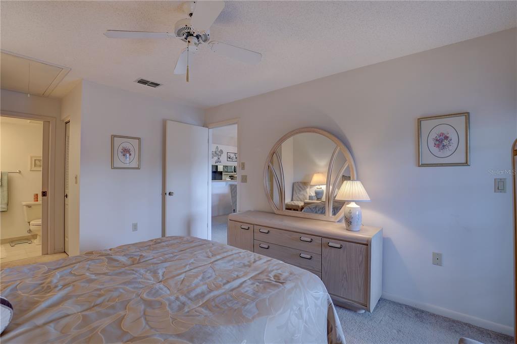 2131 Ridge Road South, Unit 132 Largo, FL 33778 - Photo 18 of 32 a bedroom with a bed and a dresser