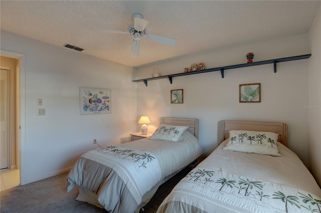 2131 Ridge Road South, Unit 132 Largo, FL 33778 - Photo 23 of 32 a bedroom with a bed and a lamp on the dresser