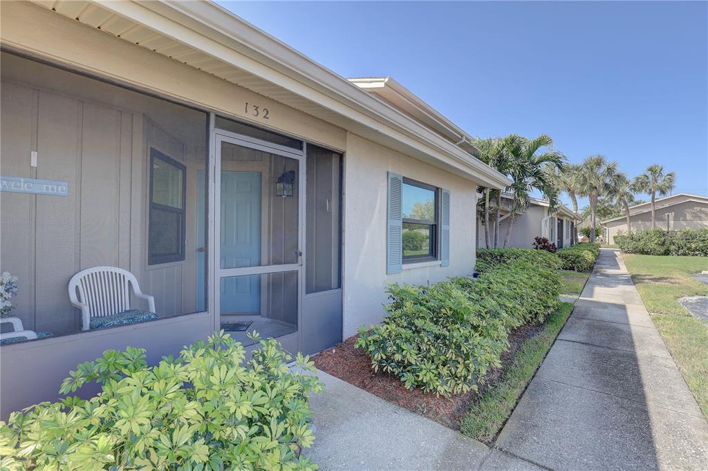 2131 Ridge Road South, Unit 132 Largo, FL 33778 - Photo 3 of 32 a front view of a house with garden