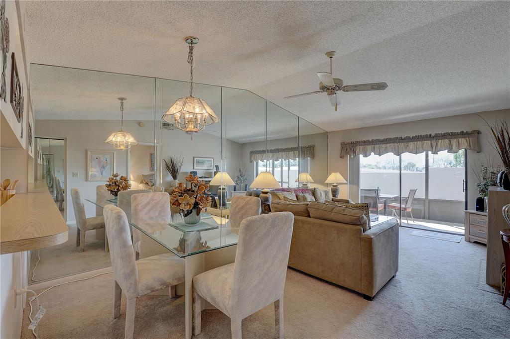 2131 Ridge Road South, Unit 132 Largo, FL 33778 - Photo 8 of 32 a dining room with furniture a chandelier and window