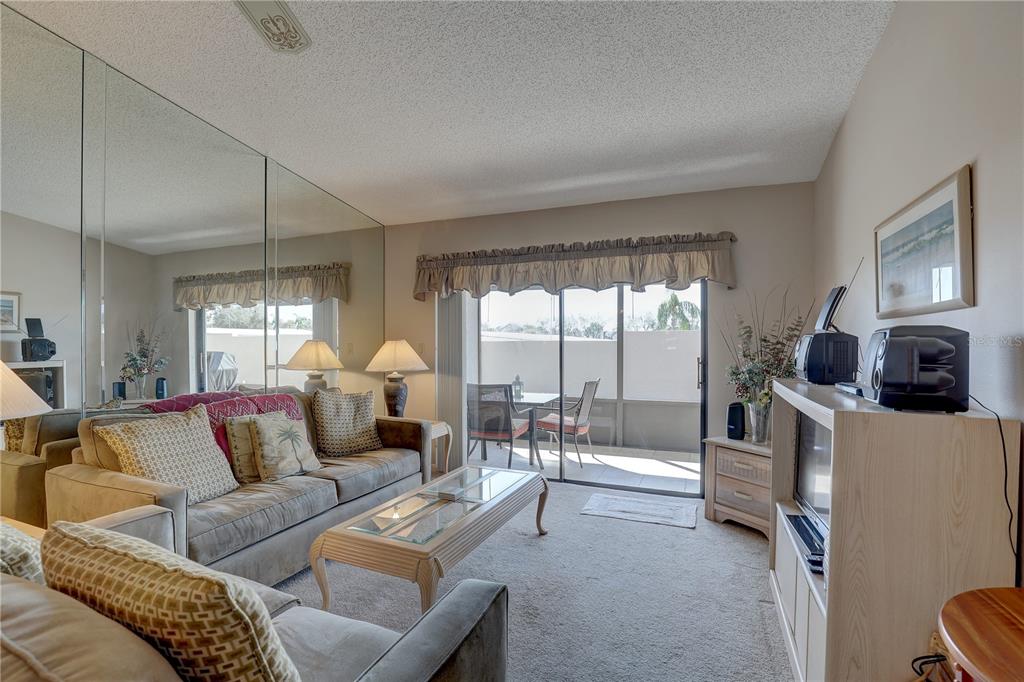 2131 Ridge Road South, Unit 132 Largo, FL 33778 - Photo 10 of 32 a living room with furniture and a large window