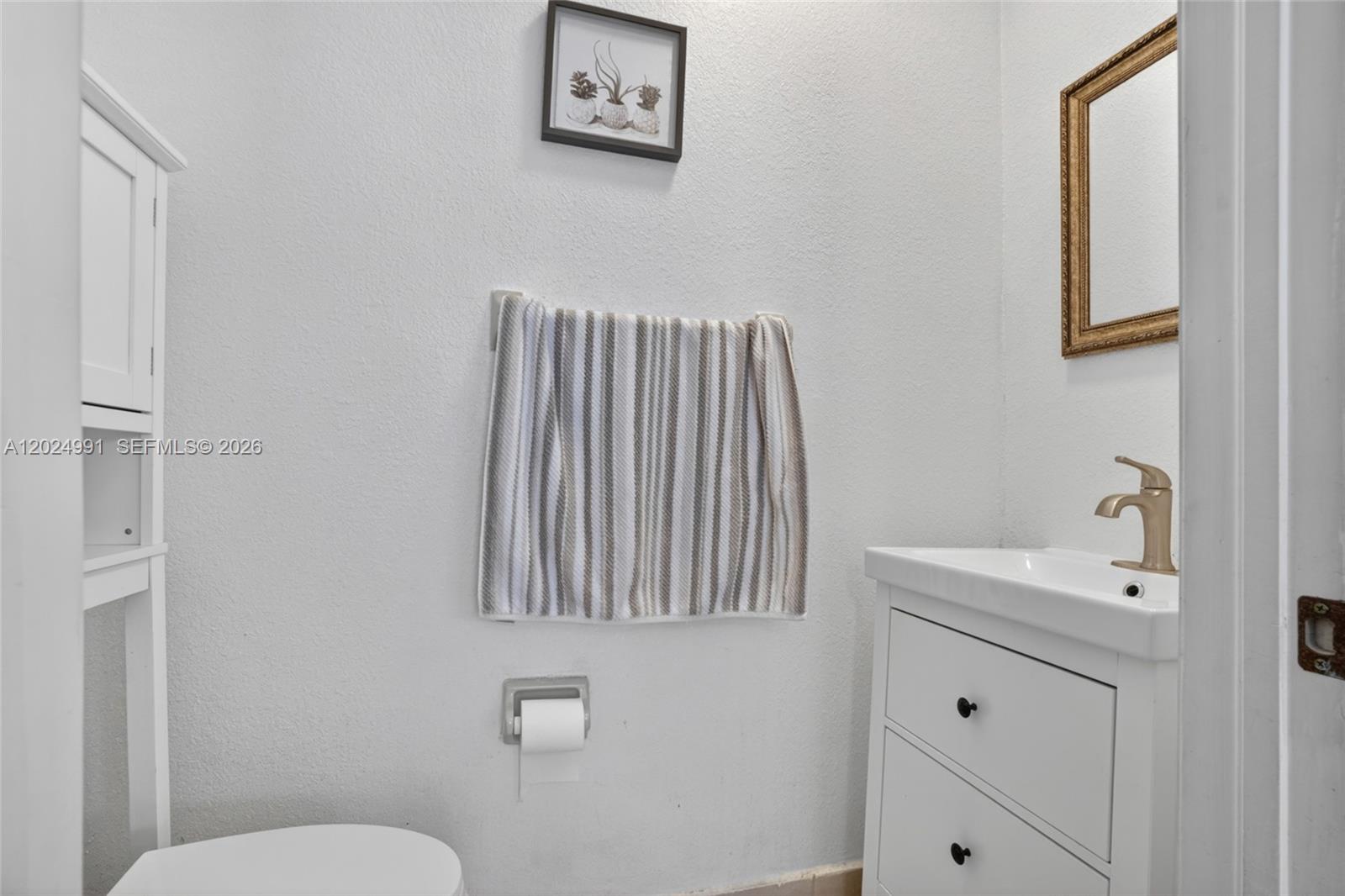 16651 Southwest 79th Terrace Miami, FL 33193 - Photo 9 of 34 a bathroom with a sink a toilet and mirror