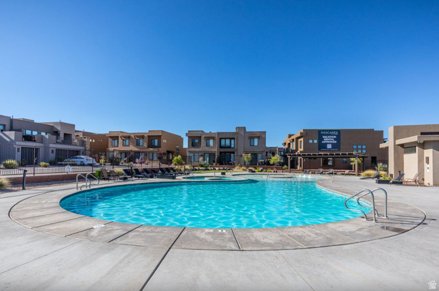 1622 Canyon Tree Drive St. George, UT 84770 - Photo 7 of 34 Resort-style swimming pool with integrated spa, surrounded by a concrete deck and a range of outdoor seating