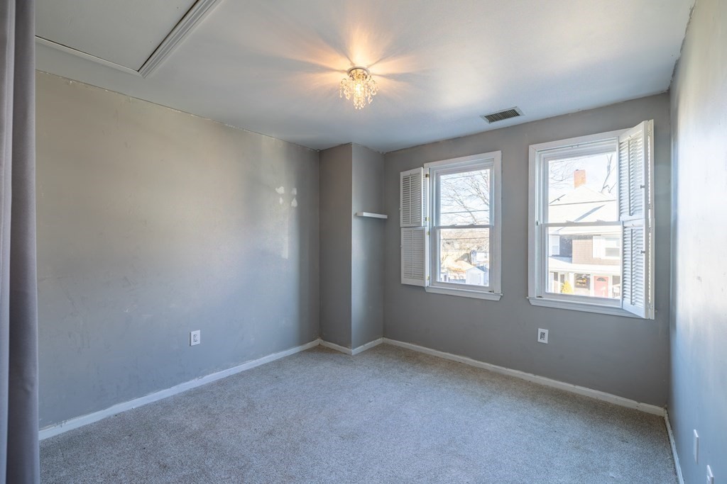 12 Pickett Street, Unit H Beverly, MA 01915 - Photo 15 of 31 an empty room with windows and chandelier fan
