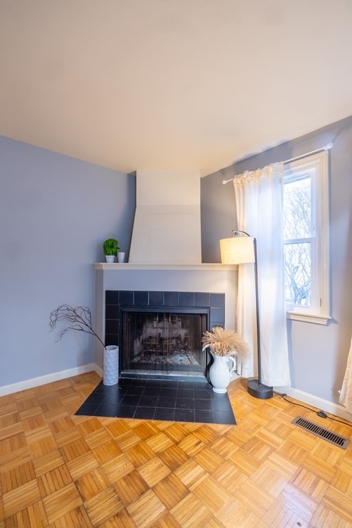 12 Pickett Street, Unit H Beverly, MA 01915 - Photo 17 of 31 a bedroom with a bed and a fireplace