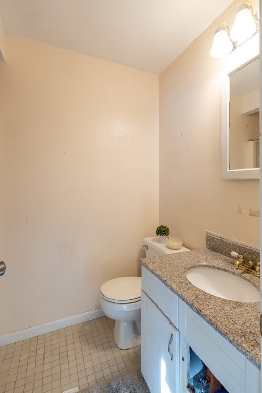 12 Pickett Street, Unit H Beverly, MA 01915 - Photo 20 of 31 a bathroom with a granite countertop toilet and sink