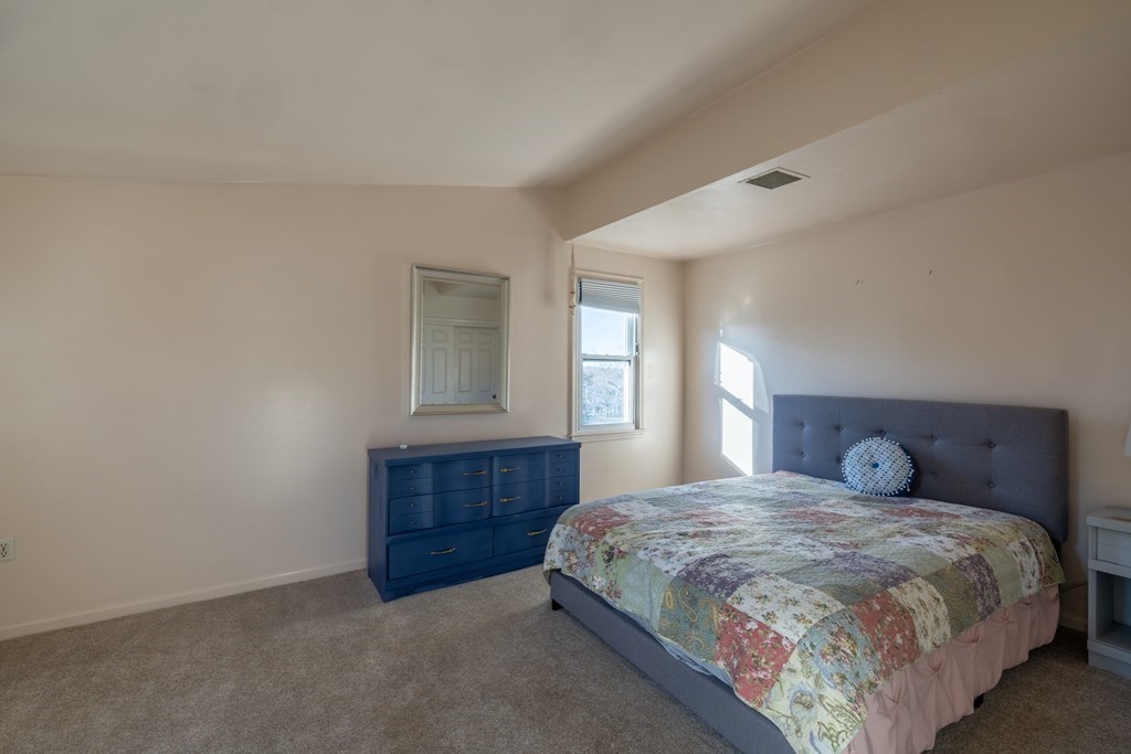 12 Pickett Street, Unit H Beverly, MA 01915 - Photo 21 of 31 a bedroom with a bed and window
