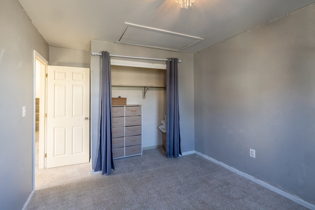 12 Pickett Street, Unit H Beverly, MA 01915 - Photo 22 of 31 an empty room with closet and wooden floor