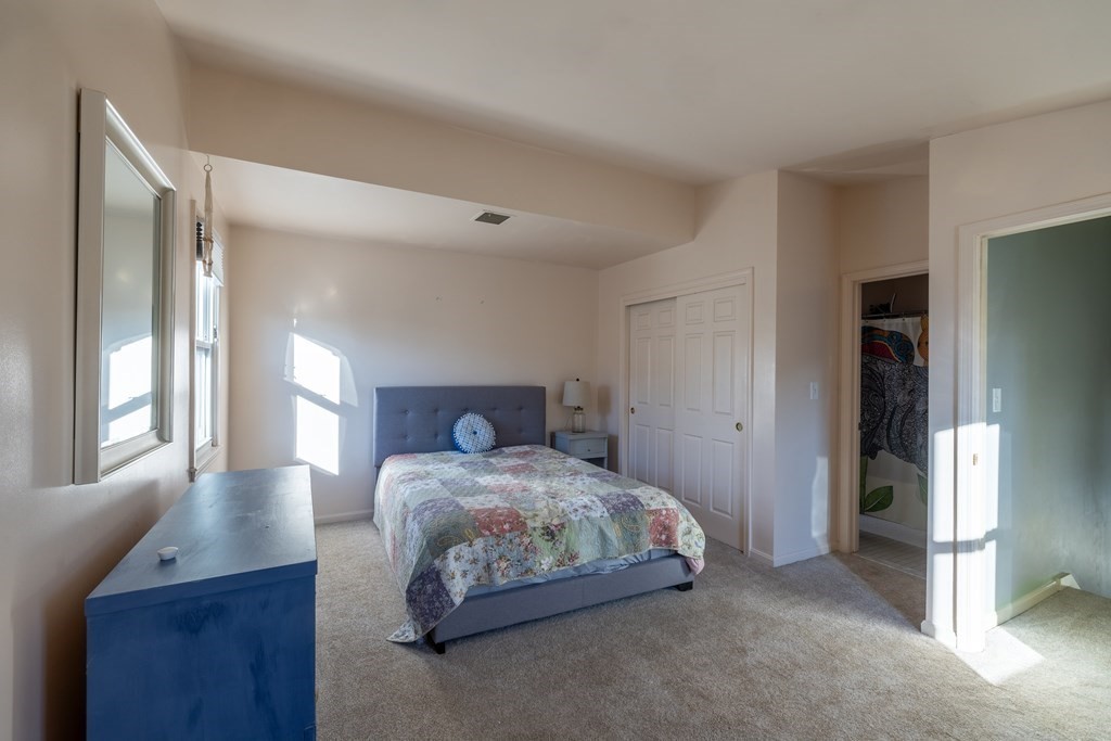 12 Pickett Street, Unit H Beverly, MA 01915 - Photo 24 of 31 a bedroom with a bed and a window