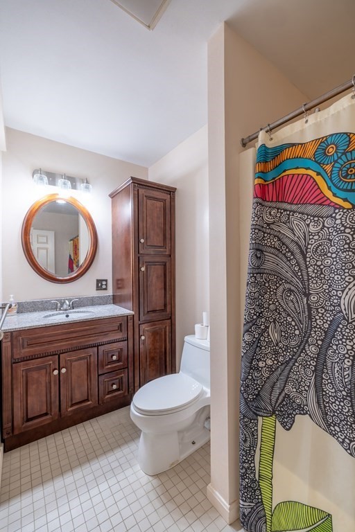 12 Pickett Street, Unit H Beverly, MA 01915 - Photo 25 of 31 a bathroom with a toilet a sink and a mirror