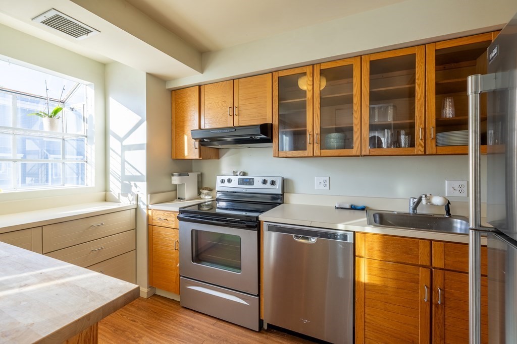 12 Pickett Street, Unit H Beverly, MA 01915 - Photo 3 of 31 a kitchen with stainless steel appliances granite countertop a stove and a sink