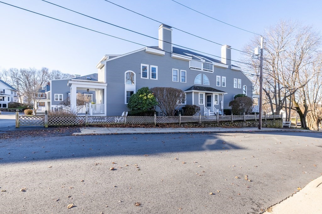 12 Pickett Street, Unit H Beverly, MA 01915 - Photo 31 of 31 a front view of a building with lots of trees and plants