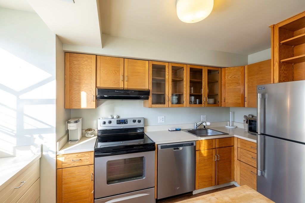 12 Pickett Street, Unit H Beverly, MA 01915 - Photo 4 of 31 a kitchen with stainless steel appliances a stove a sink and a refrigerator
