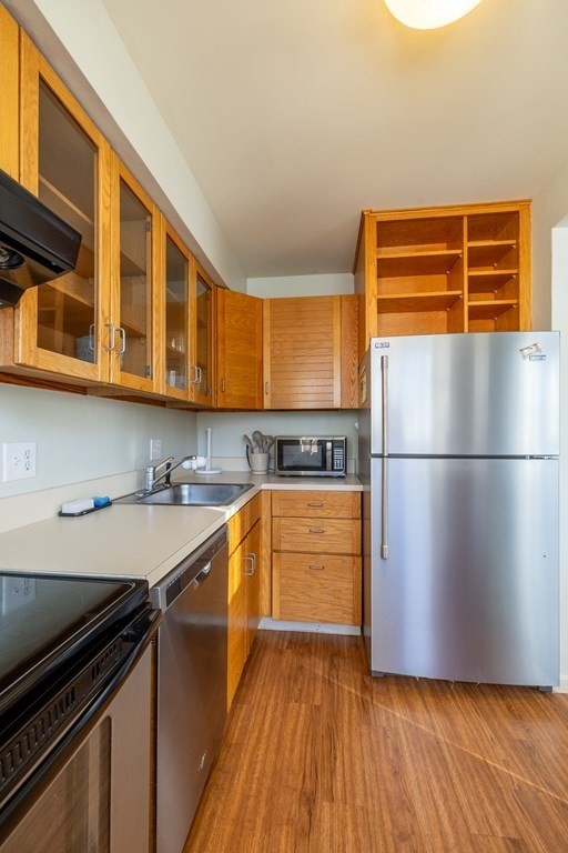 12 Pickett Street, Unit H Beverly, MA 01915 - Photo 6 of 31 a kitchen with stainless steel appliances granite countertop a refrigerator a stove and a sink