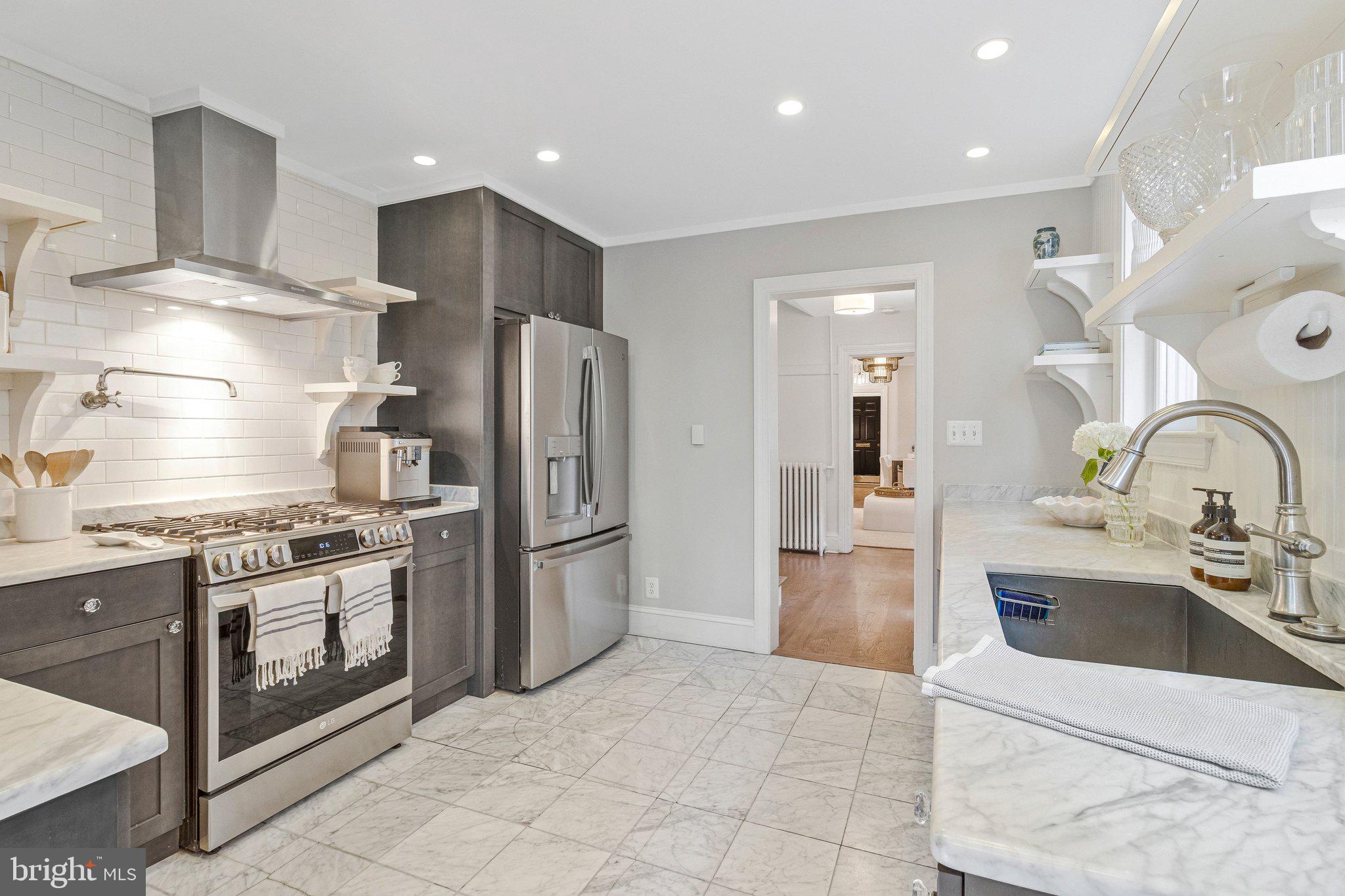 611 G Street Southeast Washington, DC 20003 - Photo 11 of 32 a kitchen with stainless steel appliances granite countertop a refrigerator and a stove