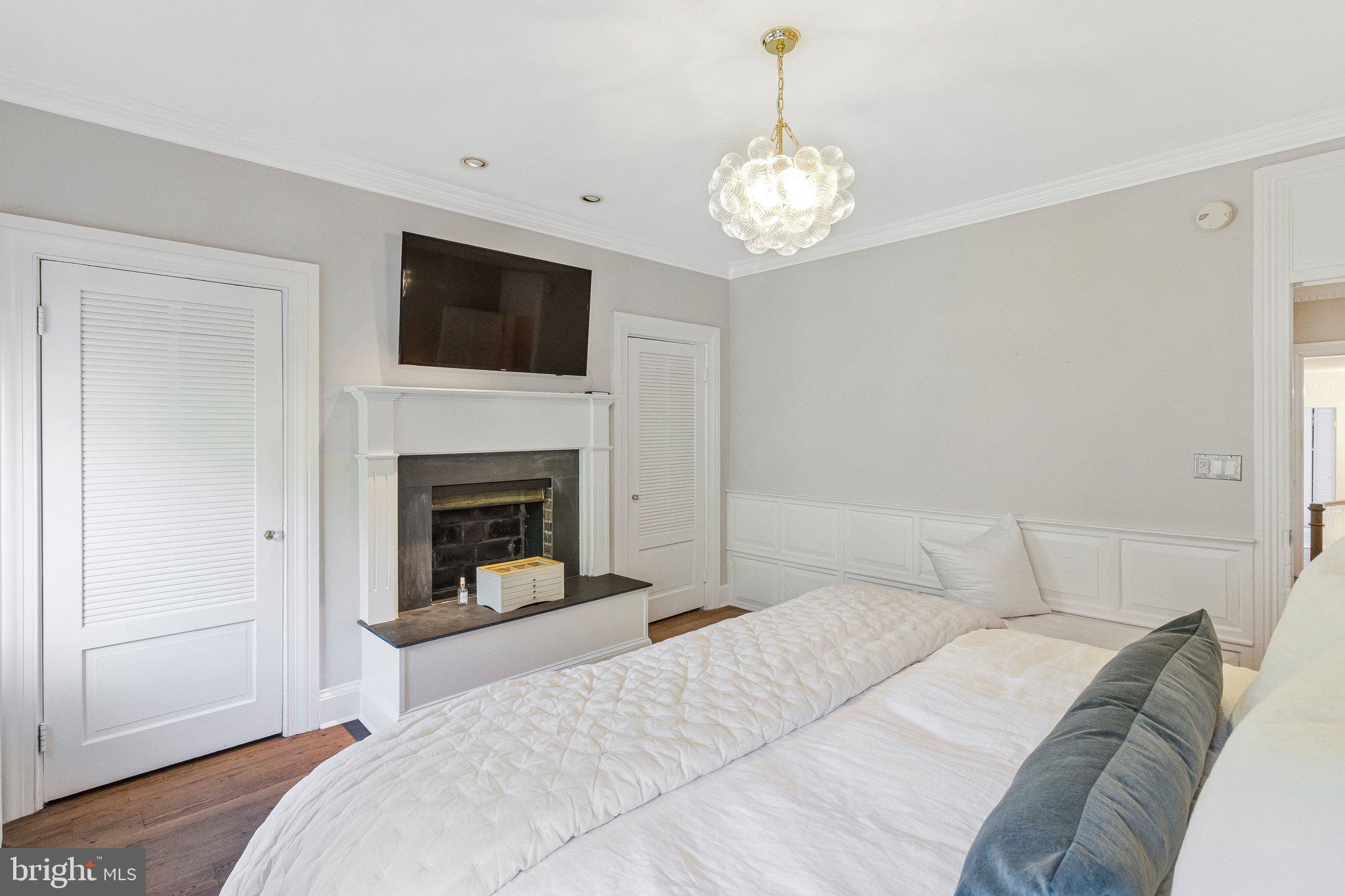 611 G Street Southeast Washington, DC 20003 - Photo 20 of 32 a bedroom with a bed and a fireplace