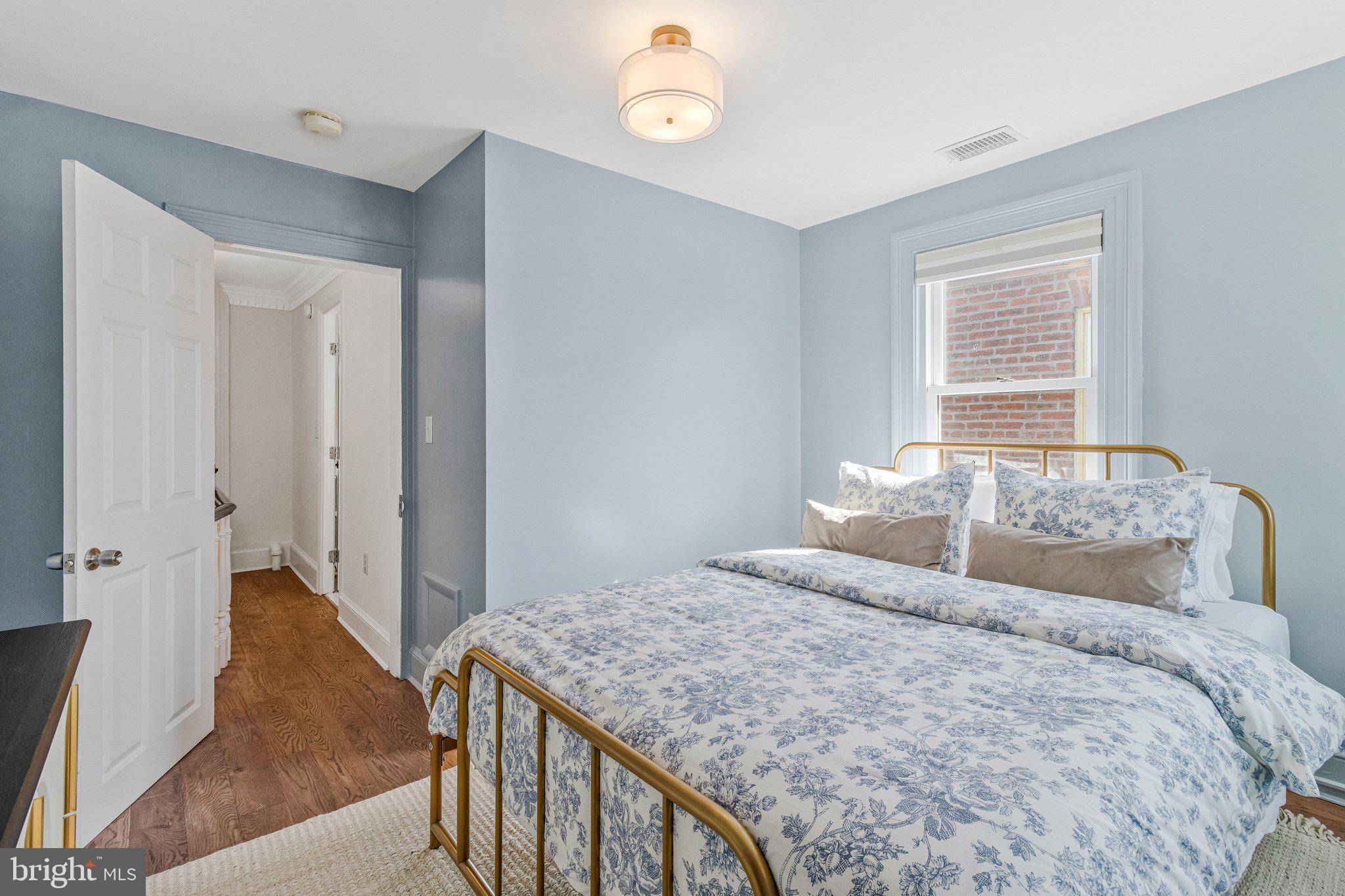 611 G Street Southeast Washington, DC 20003 - Photo 23 of 32 a bedroom with a bed and a chandelier