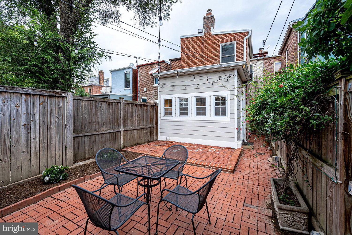 611 G Street Southeast Washington, DC 20003 - Photo 29 of 32 a backyard of a house with table and chairs