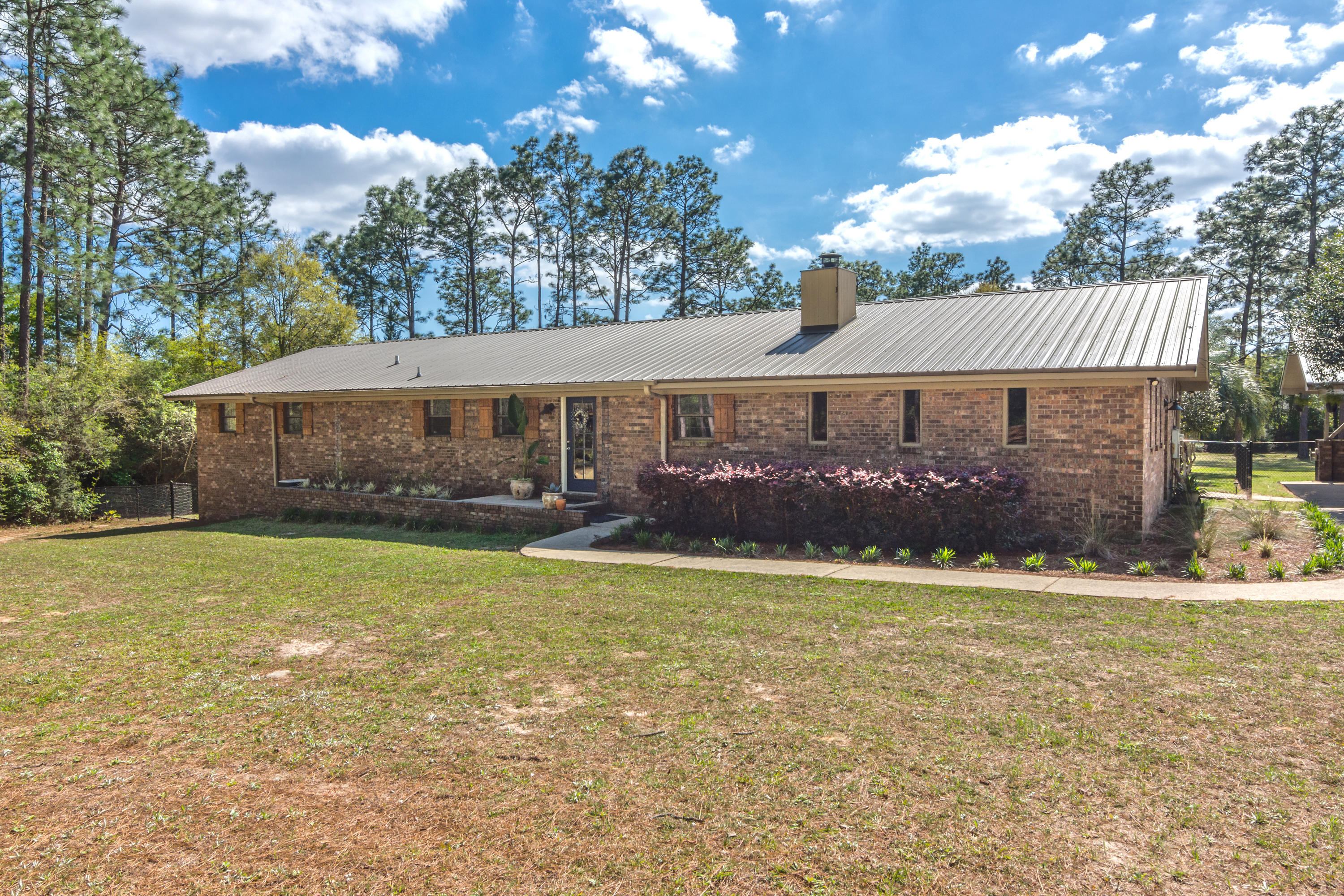 658 Ridge Lake Road Crestview, FL 32536 - Photo 1 of 47 a front view of a house with a garden