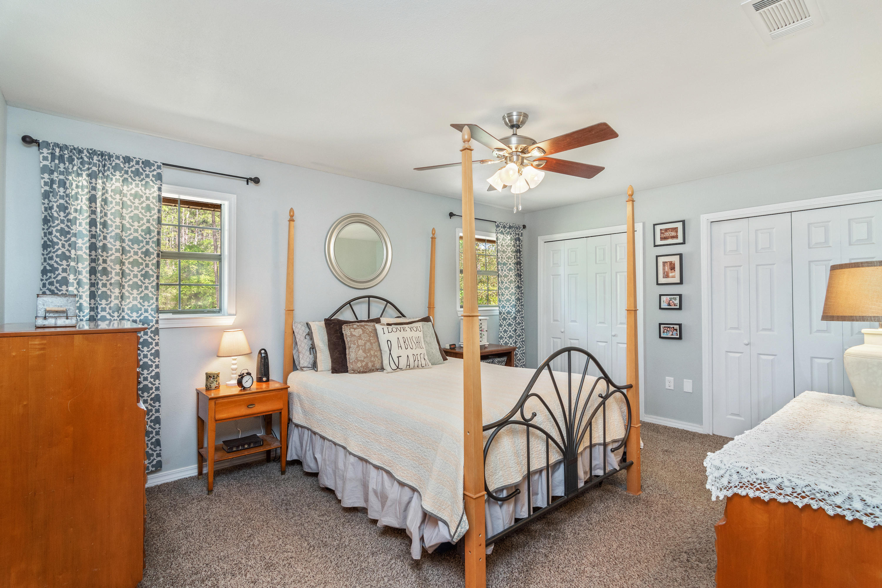 658 Ridge Lake Road Crestview, FL 32536 - Photo 21 of 47 a bed room with a bed and a lamp