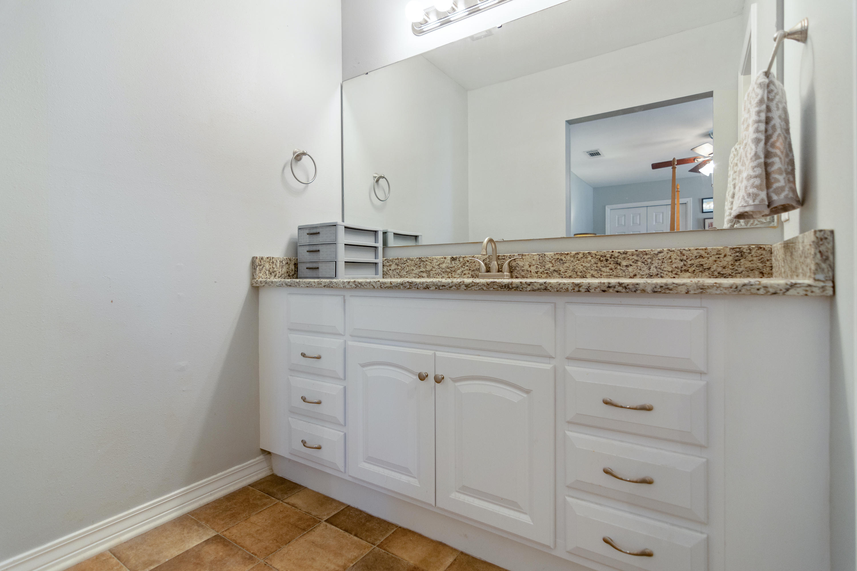 658 Ridge Lake Road Crestview, FL 32536 - Photo 23 of 47 a bathroom with a granite countertop sink and a mirror