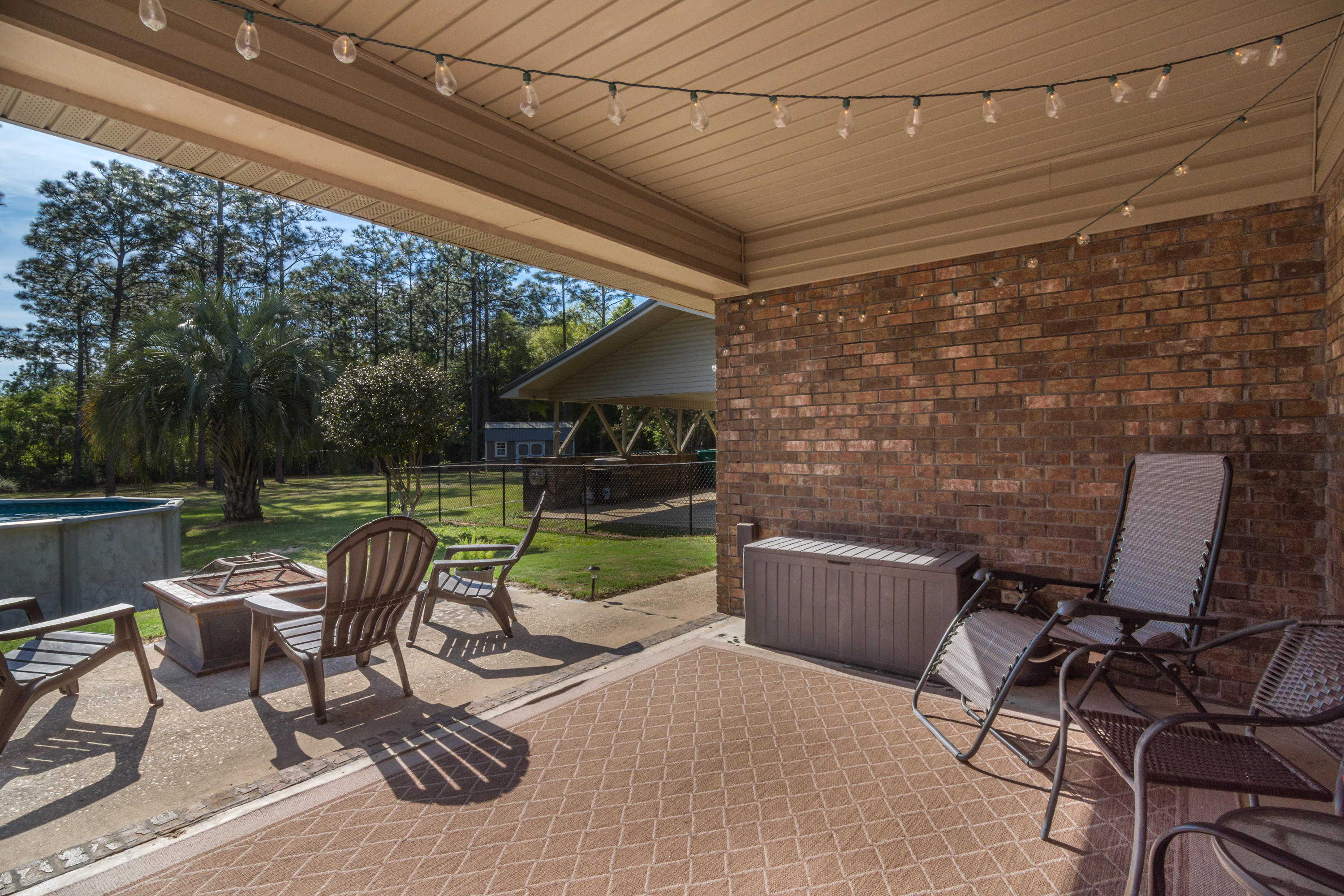 658 Ridge Lake Road Crestview, FL 32536 - Photo 33 of 47 a view of a patio with a table chairs and a grill