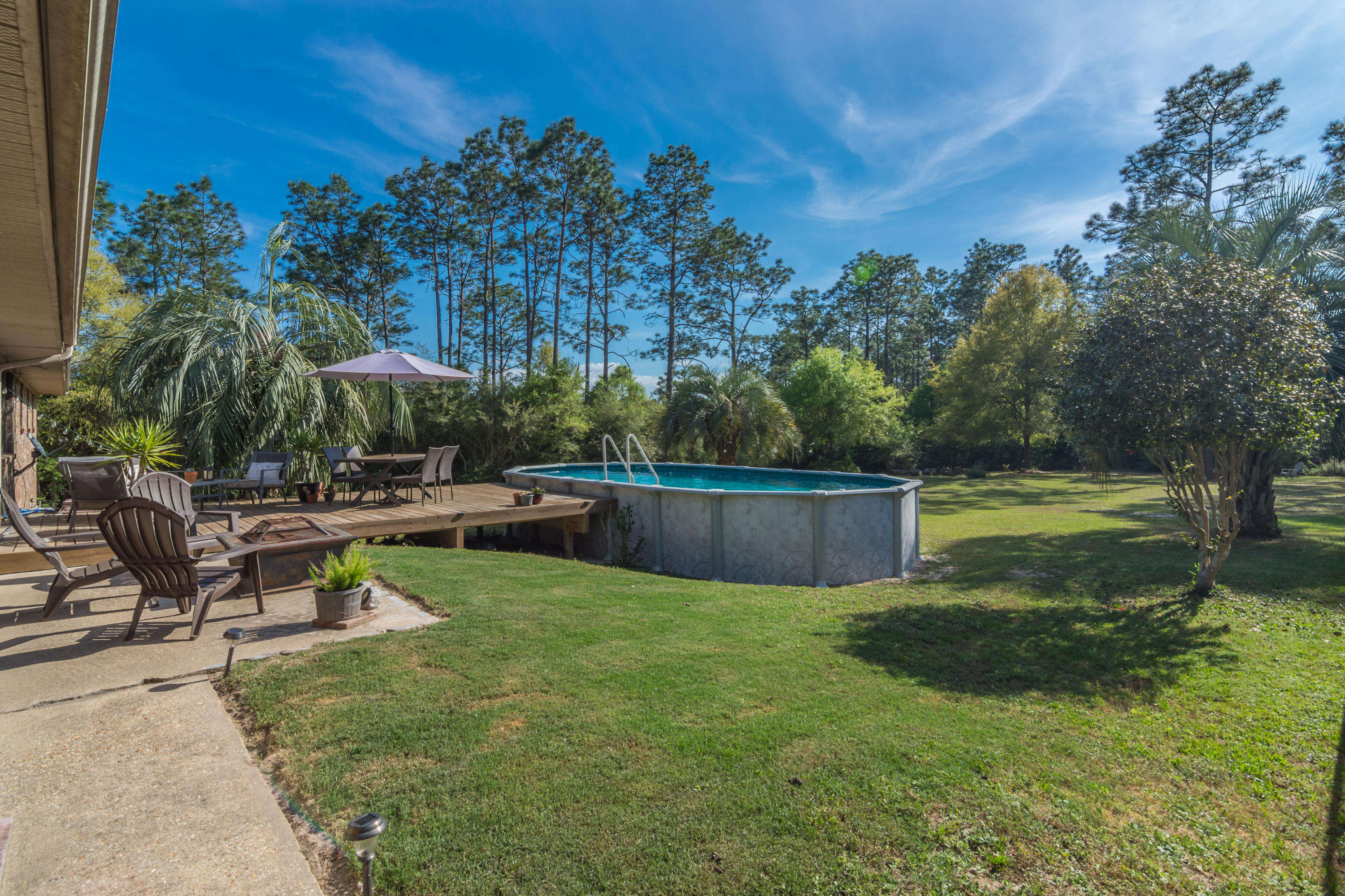 658 Ridge Lake Road Crestview, FL 32536 - Photo 35 of 47 a view of backyard with swimming pool and sitting area