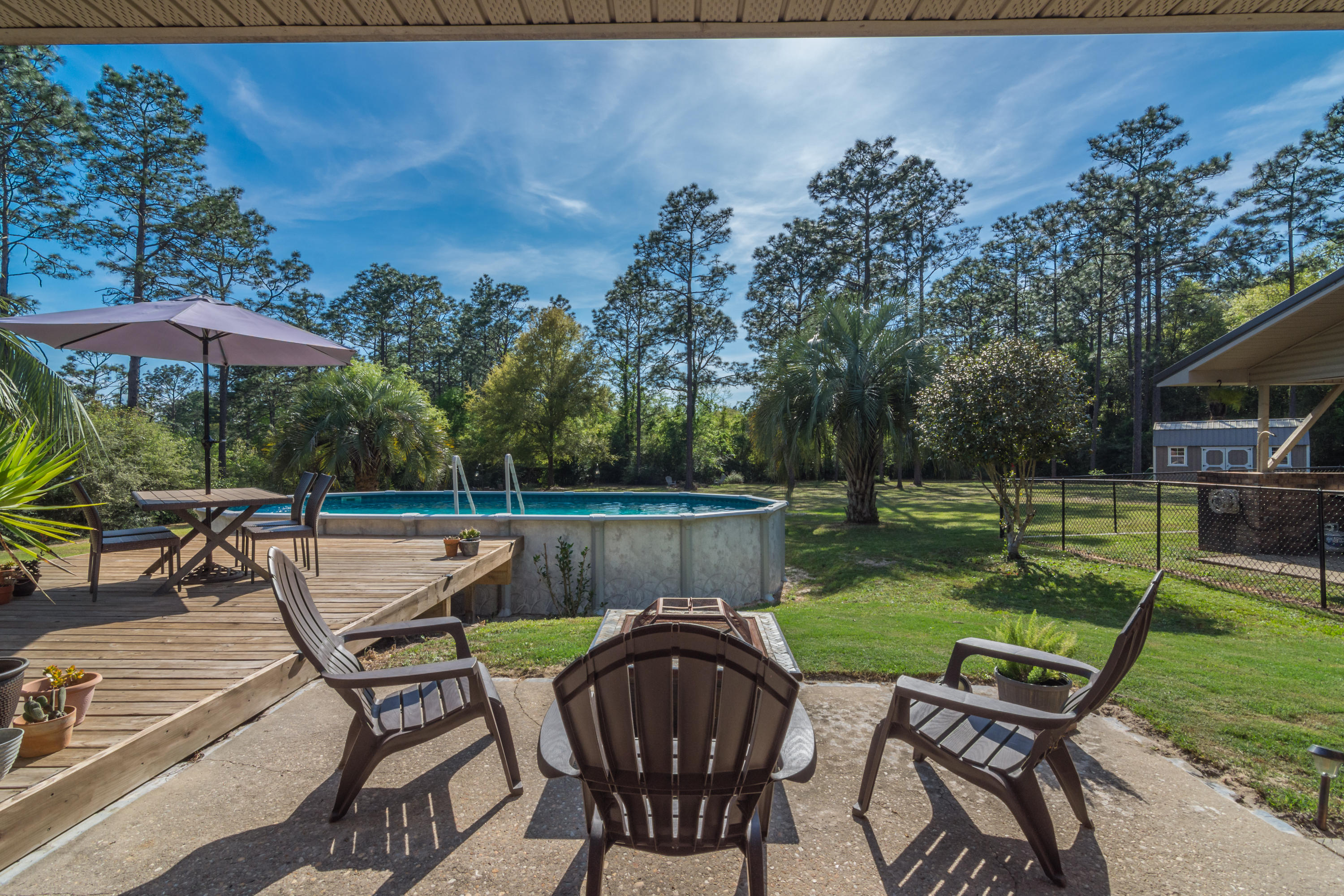 658 Ridge Lake Road Crestview, FL 32536 - Photo 36 of 47 a view of a chairs and table in the backyard