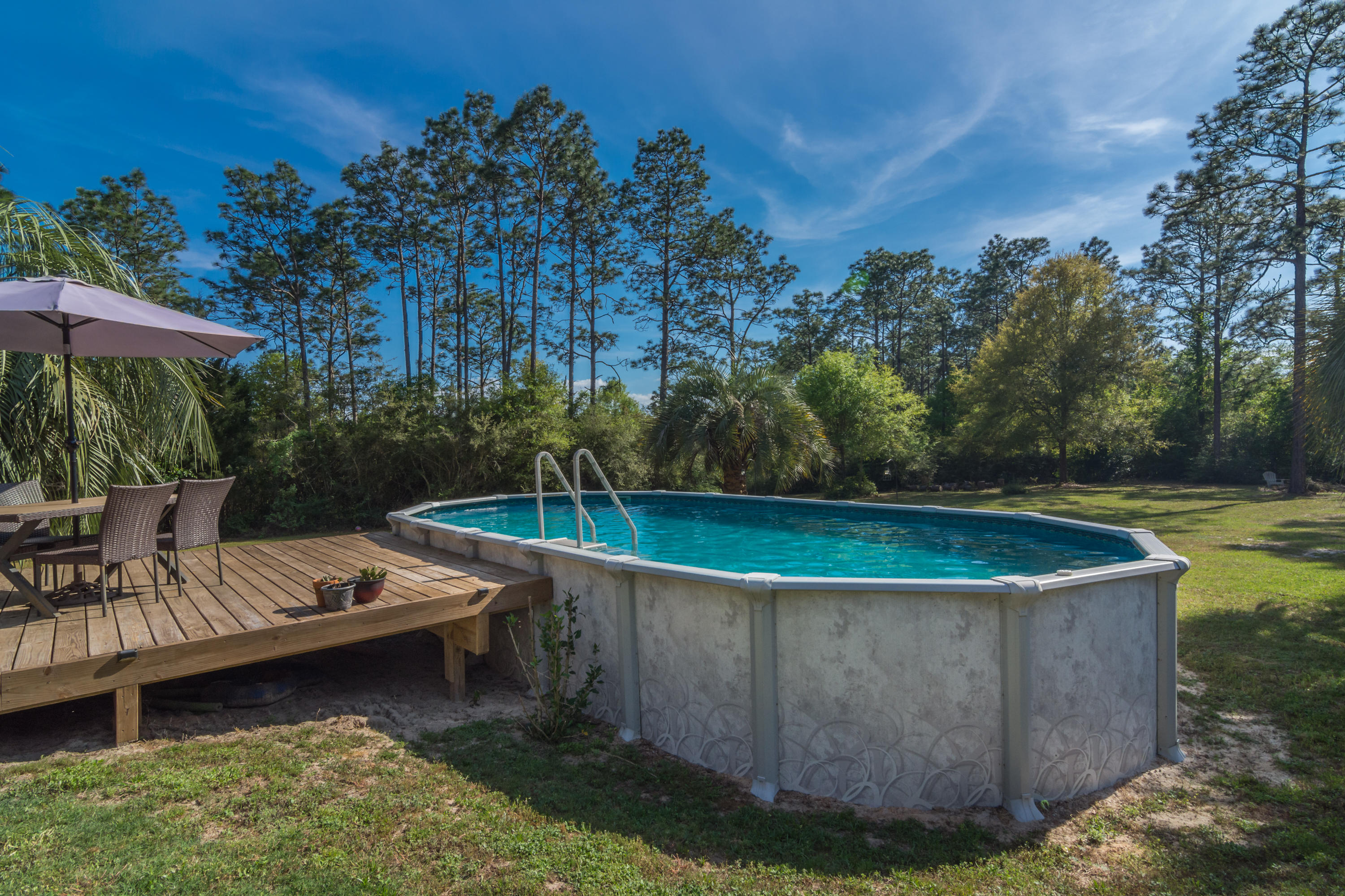 658 Ridge Lake Road Crestview, FL 32536 - Photo 38 of 47 a view of a swimming pool with a patio