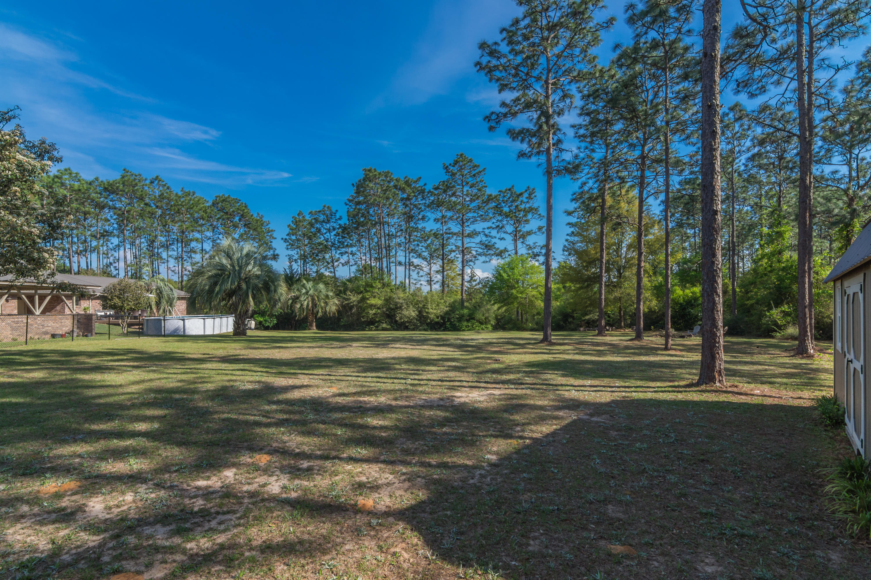 658 Ridge Lake Road Crestview, FL 32536 - Photo 42 of 47 a yard with lots of trees and buildings