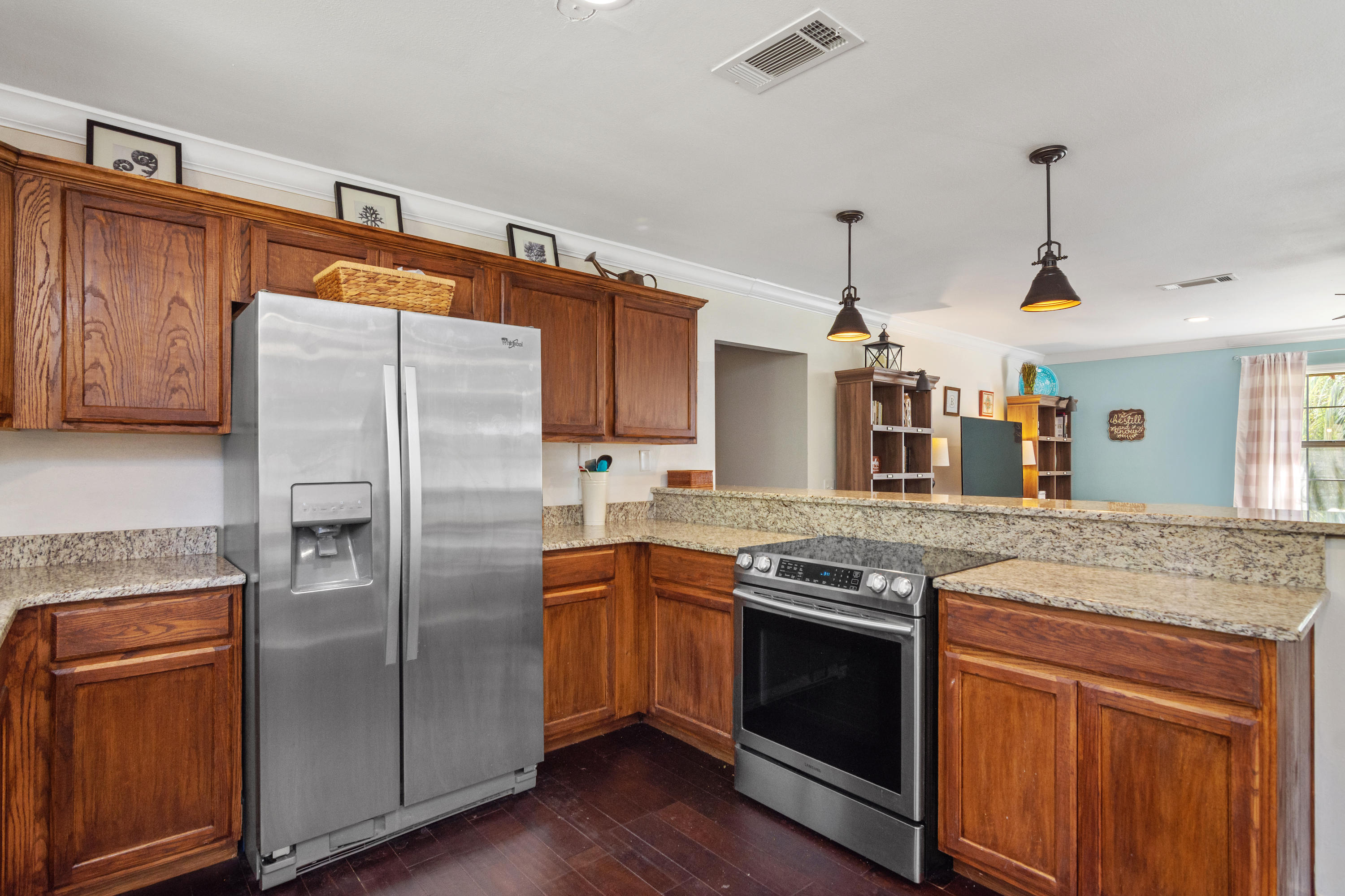 658 Ridge Lake Road Crestview, FL 32536 - Photo 10 of 47 a kitchen with stainless steel appliances granite countertop a refrigerator a sink dishwasher a stove and white cabinets with wooden floor