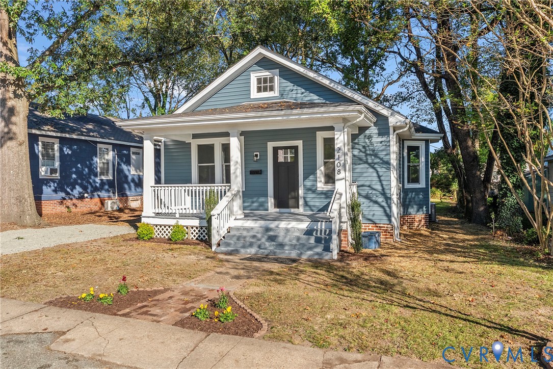 a view of a house with backyard porch and sitting area