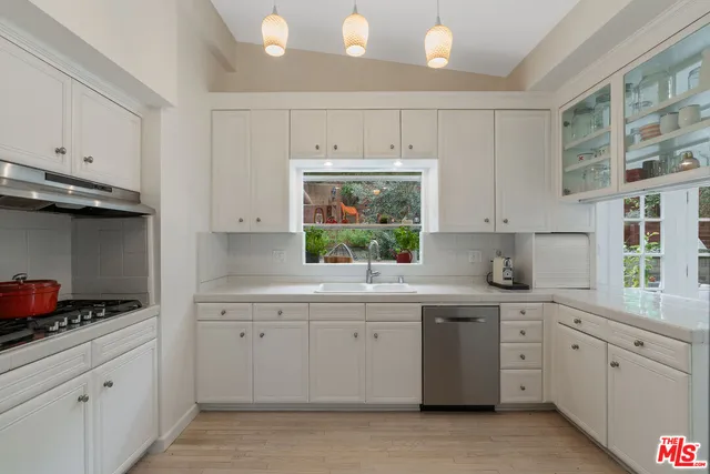 a kitchen with sink cabinets and window