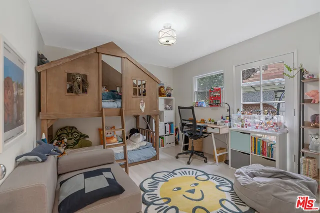 a living room with furniture and a book shelf