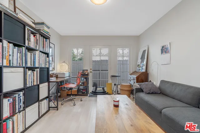 a living room with furniture a rug and a book shelf
