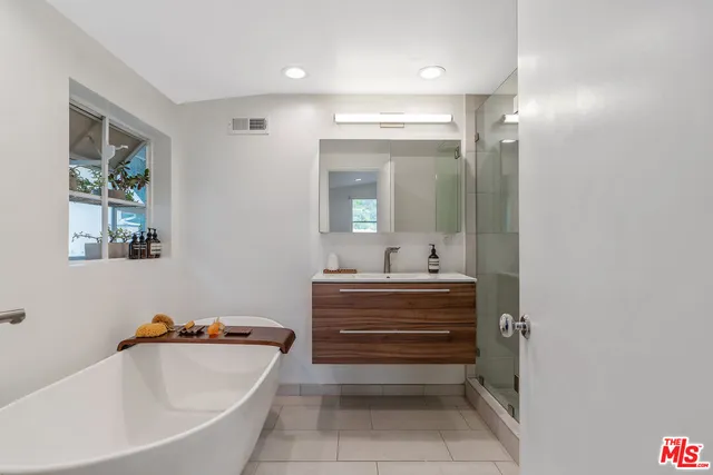 a bathroom with a bathtub and a shower