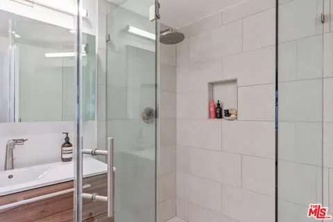a bathroom with a granite countertop sink a toilet and a mirror
