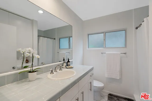 a view of a patio with couches and a table and chairs with wooden fence