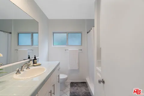 a view of a backyard with plants and a slide