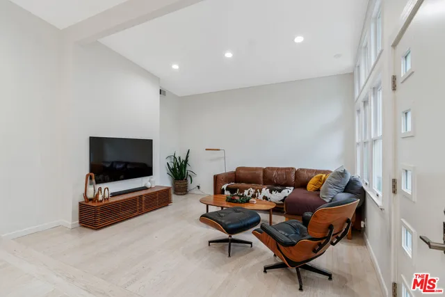 a view of an empty room with furniture and window