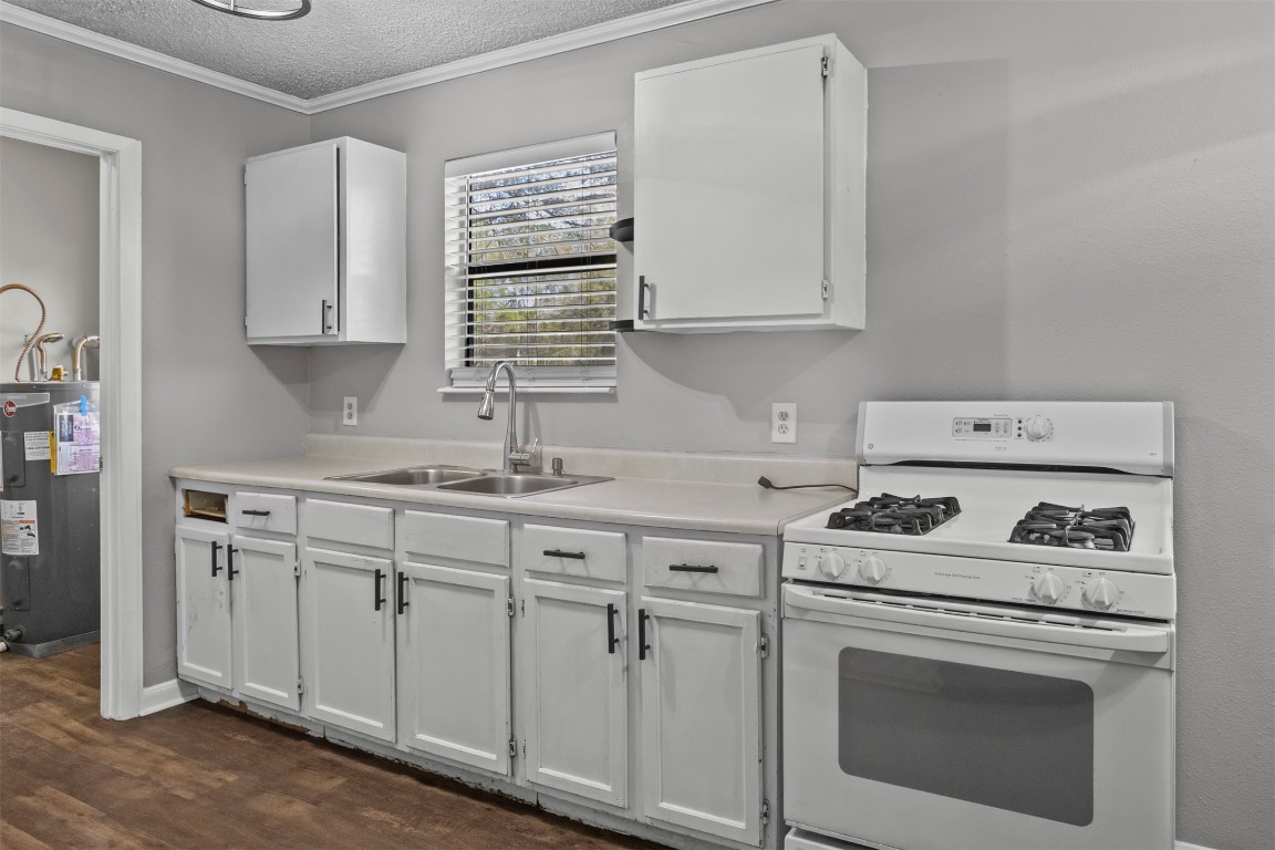 801 Campbell Acres Road Cleveland, TX 77328 - Photo 11 of 36 a kitchen with cabinets appliances a sink and a counter