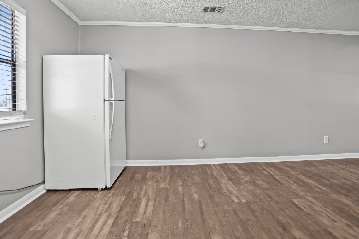 801 Campbell Acres Road Cleveland, TX 77328 - Photo 12 of 36 a view of an empty room with wooden floor and a window