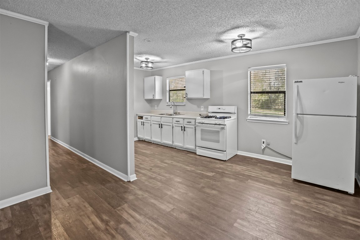 801 Campbell Acres Road Cleveland, TX 77328 - Photo 13 of 36 a view of a kitchen with wooden floor electronic appliances and cabinets